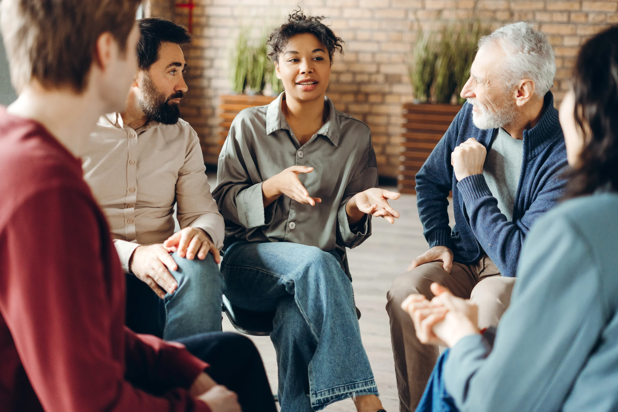 Adults participating in a supportive group counseling session.