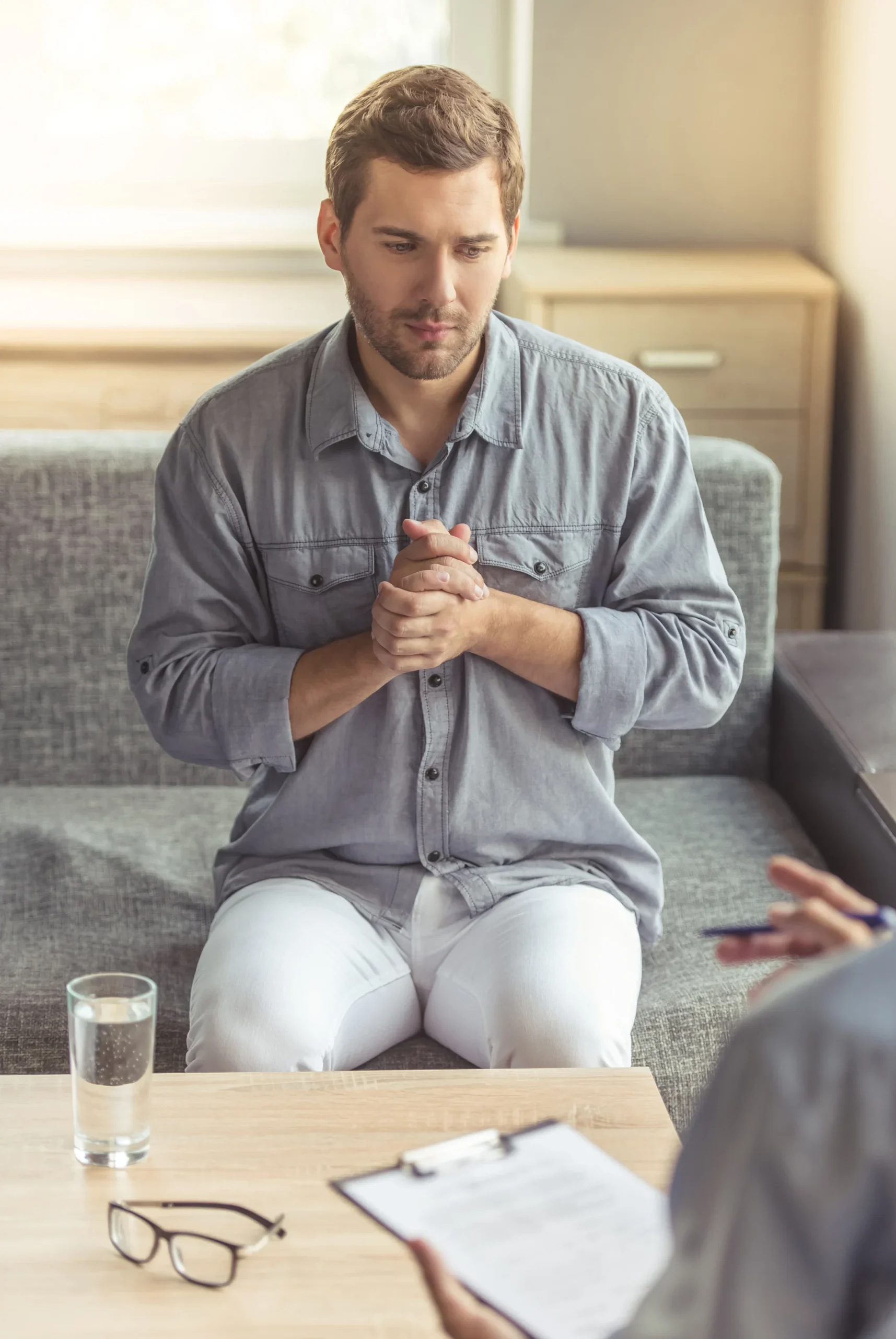 Man speaking with therapist during anxiety counseling session.