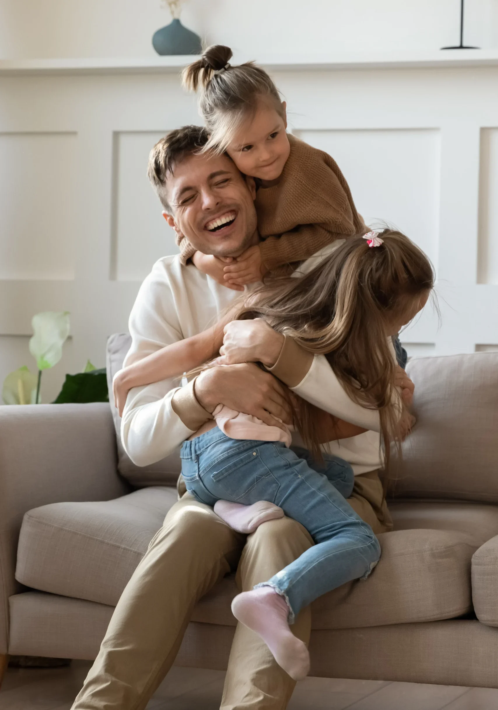 Father embracing his joyful children.