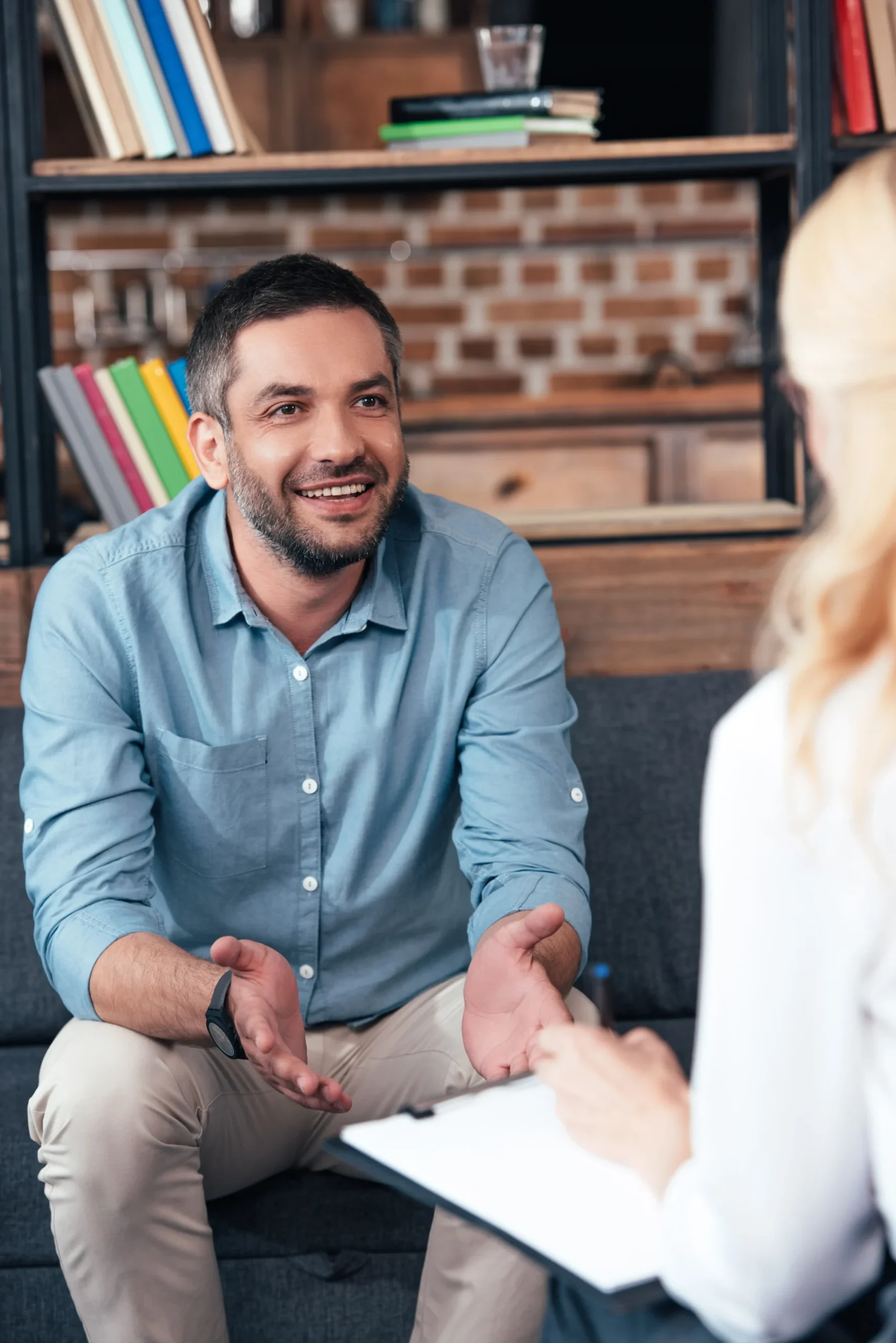 Man talking openly with a therapist during a mental health counseling session.