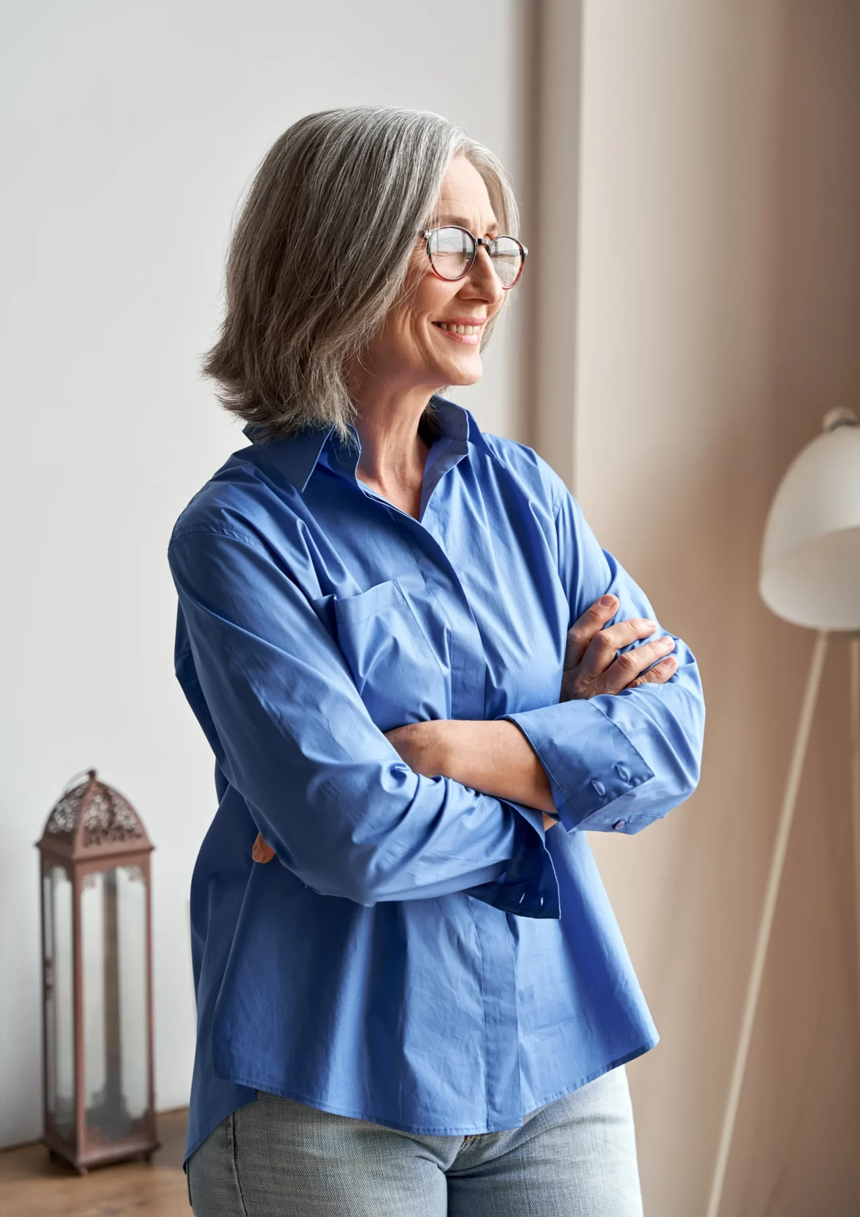 Woman in blue shirt, arms crossed.