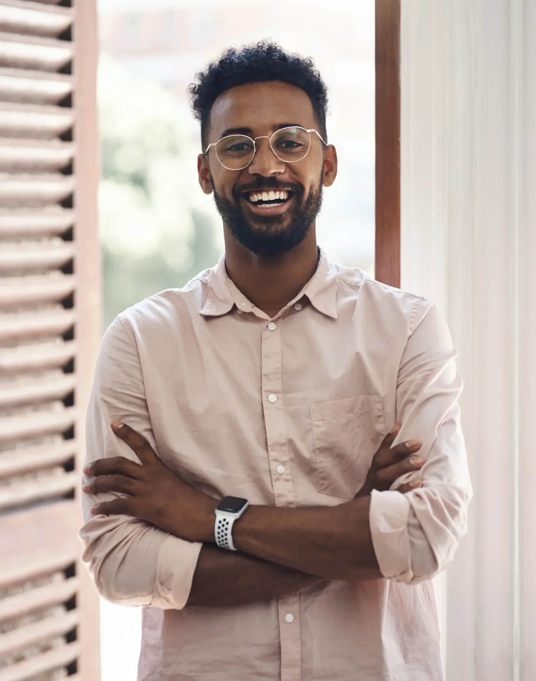 Man standing confidently in doorway.