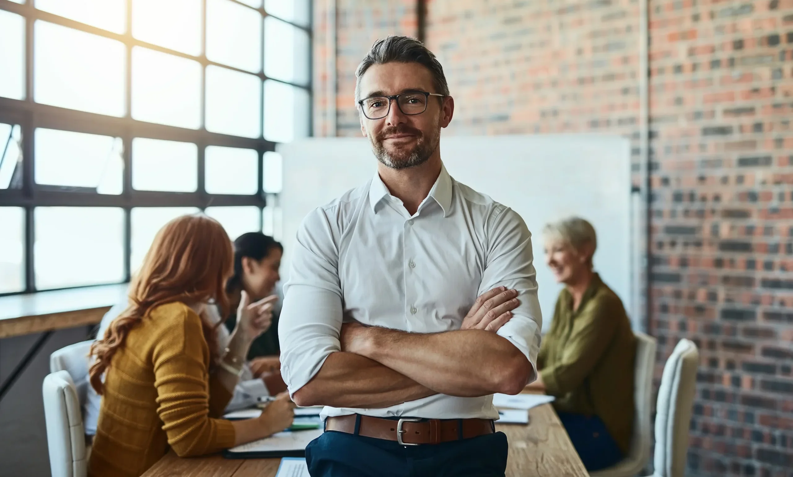 man smiling in an office setting.