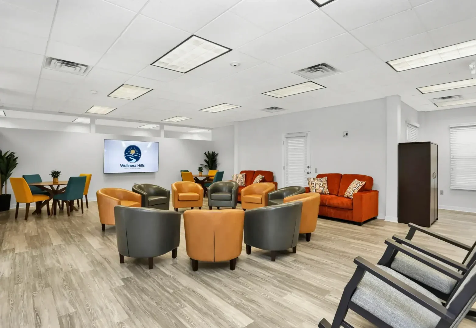 Wellness Hills mental health group therapy room with arranged chairs and comfortable seating.