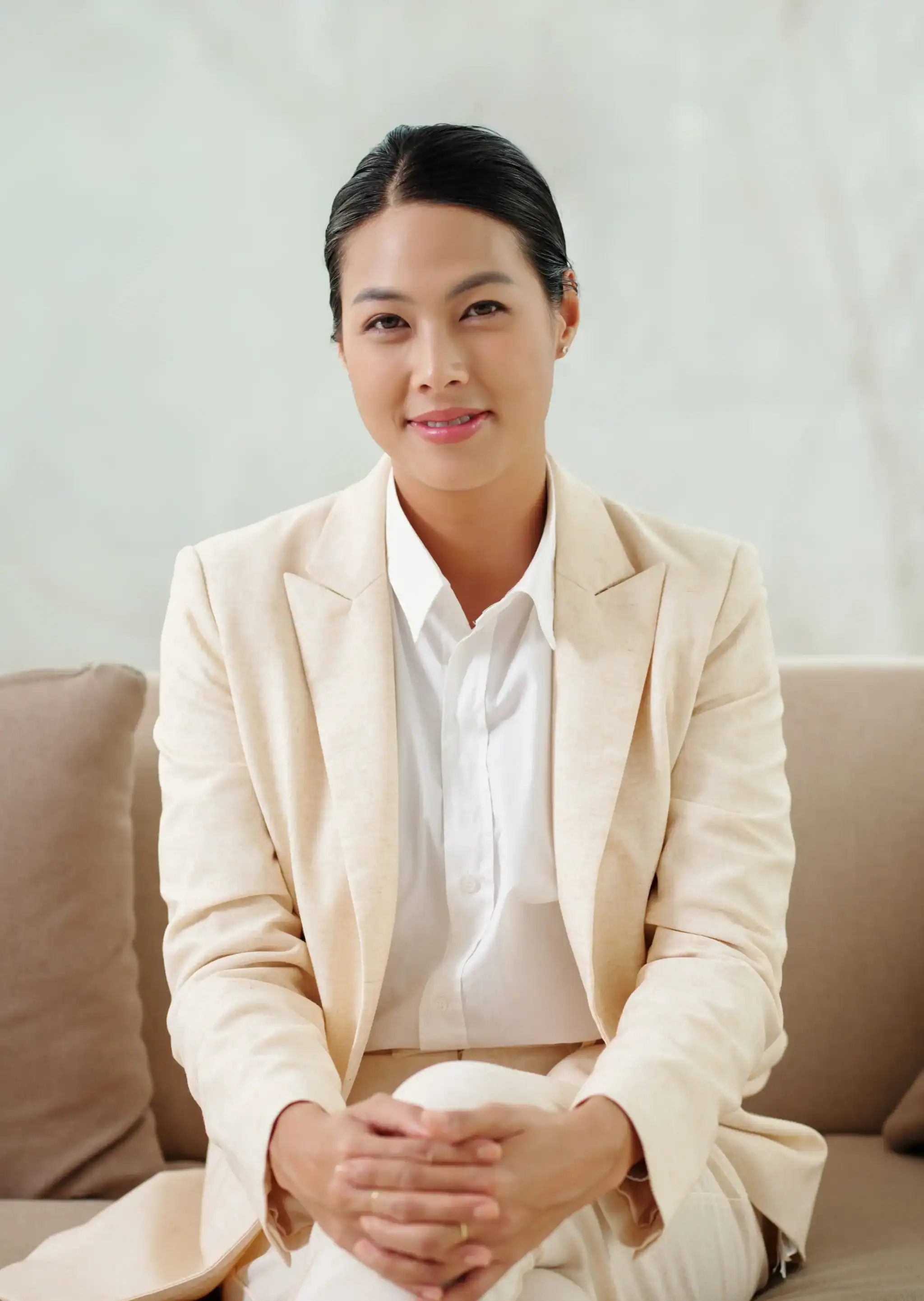 Professional female therapist seated in a calm office setting, conveying approachability and emotional support