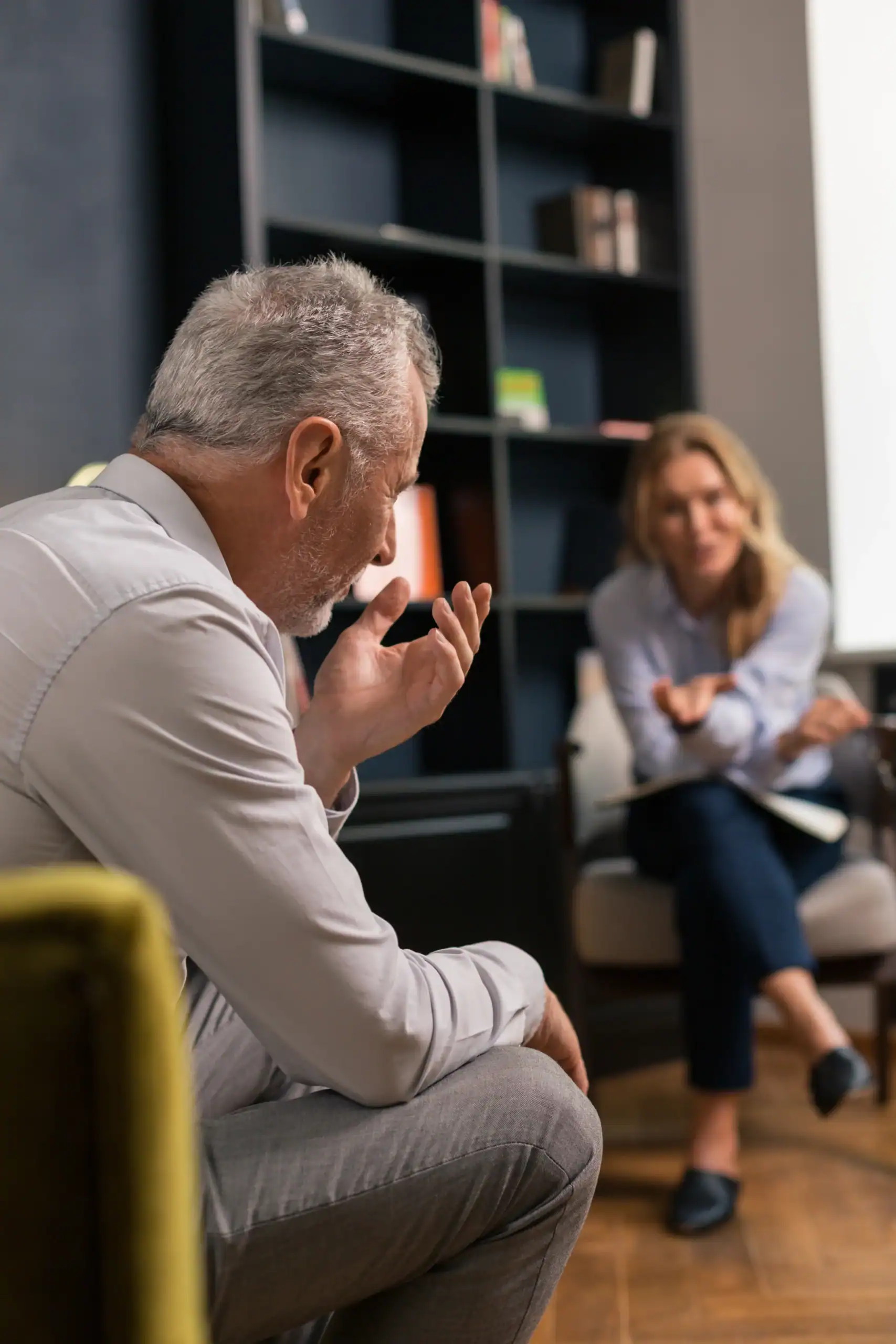 Older man speaking with a therapist during a counseling session