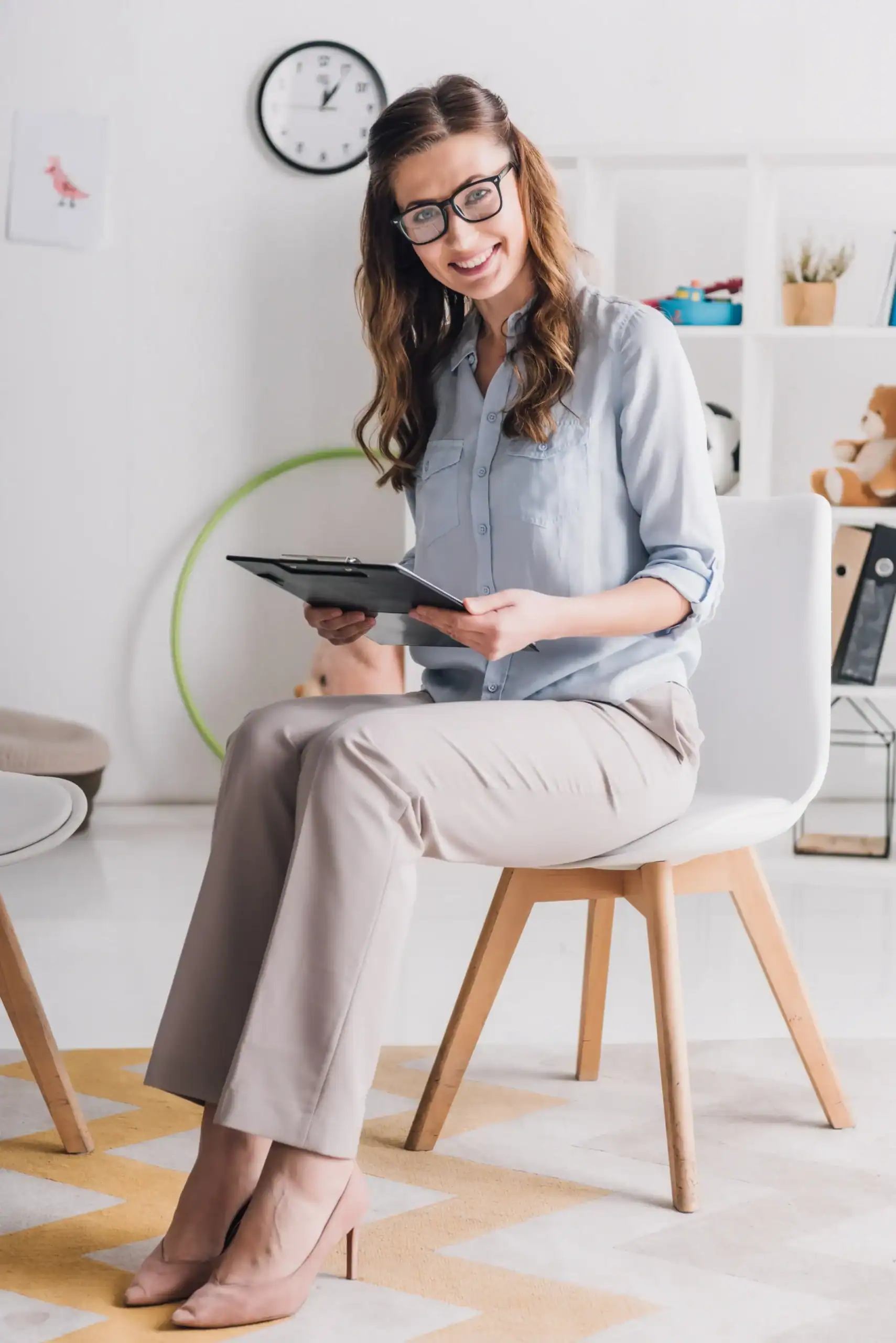 Clinician holding a clipboard in a counseling office