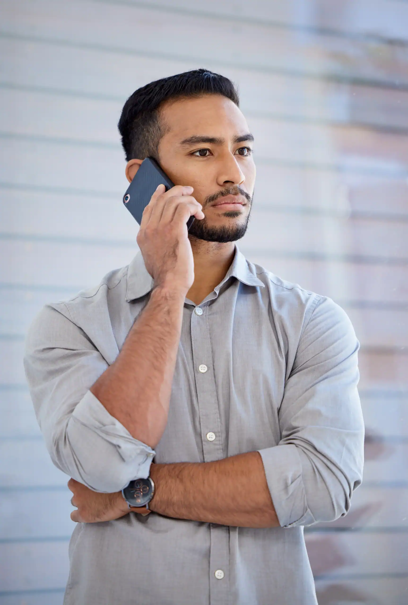Man talking on a phone call while looking thoughtful