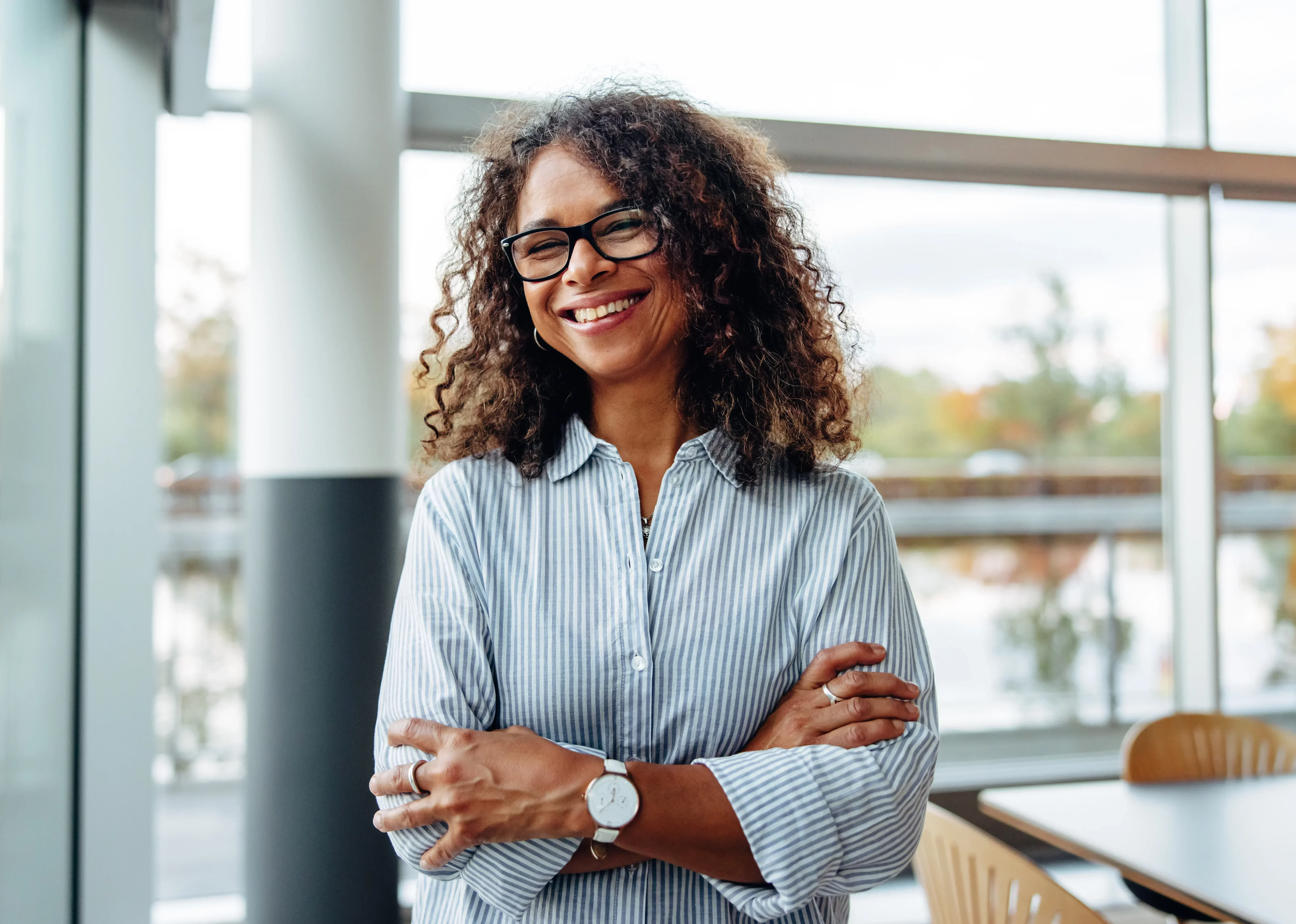 Confident woman at mental health treatment center representing recovery and success.