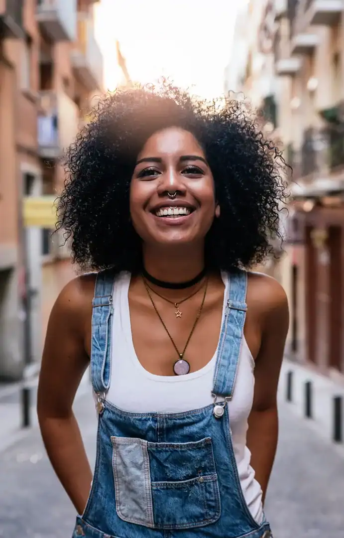 Woman smiling outdoors in a downtown street scene