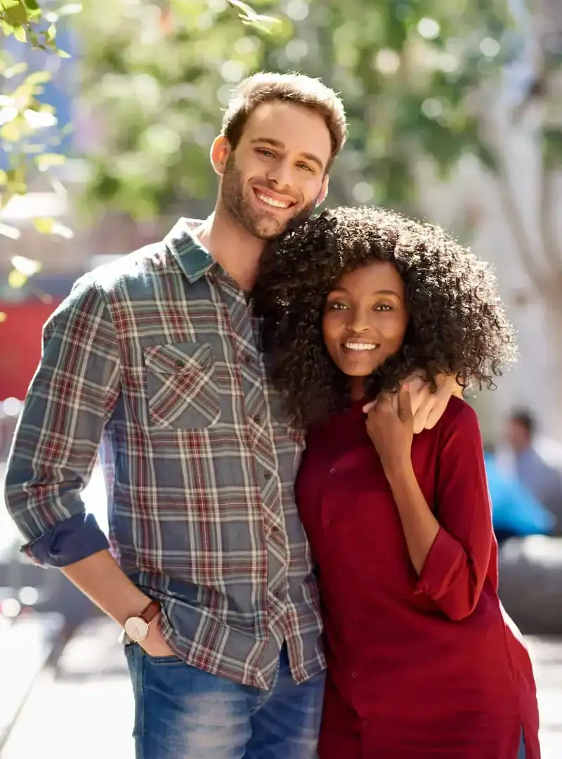 Smiling couple standing together outdoors