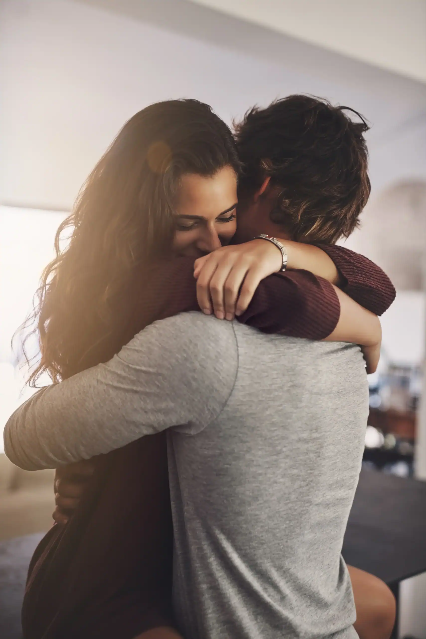 Woman and man embracing in a supportive hug, representing emotional connection, reassurance, and mental health support
