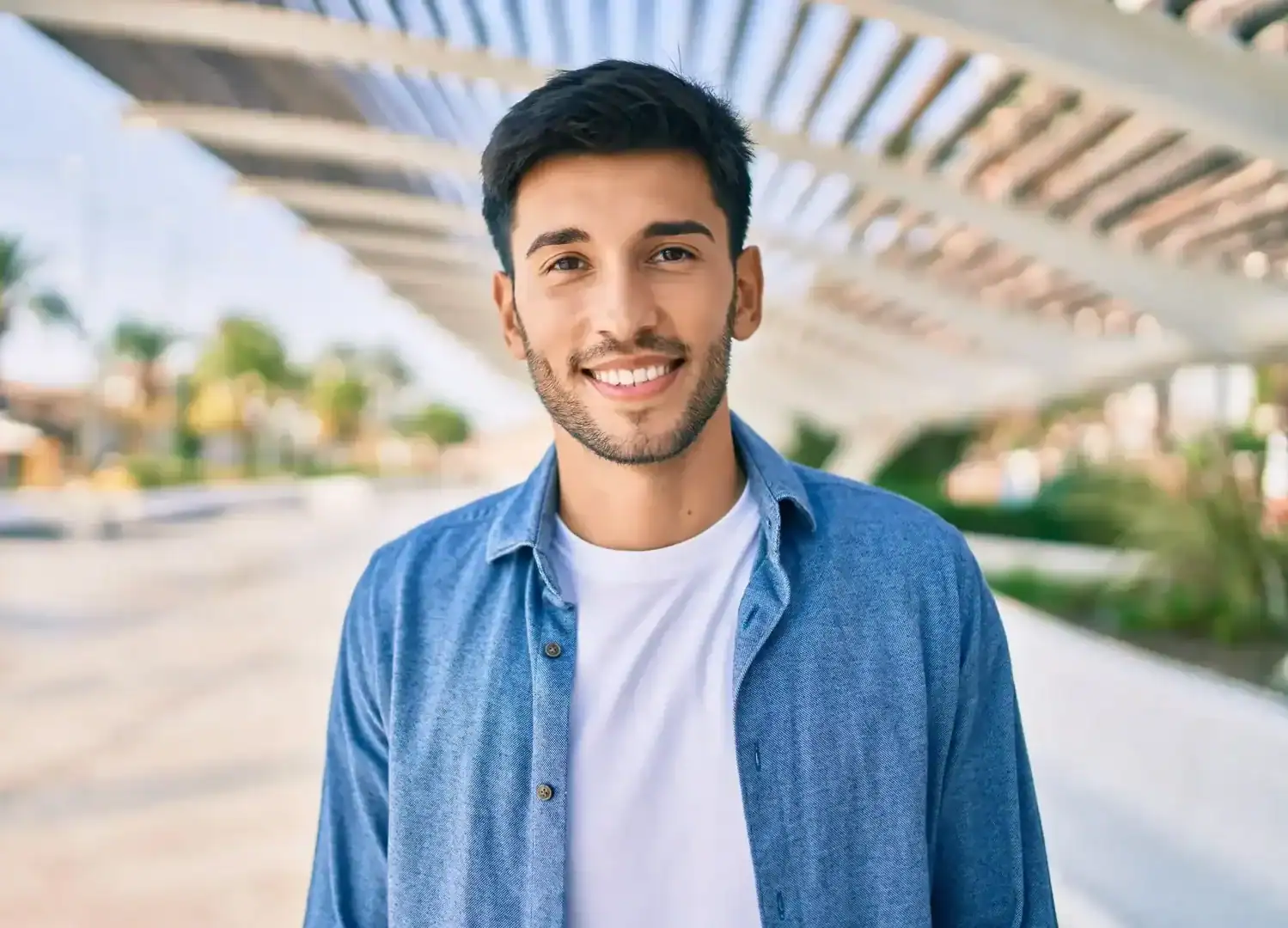 Portrait of a smiling man outside in a modern outdoor setting