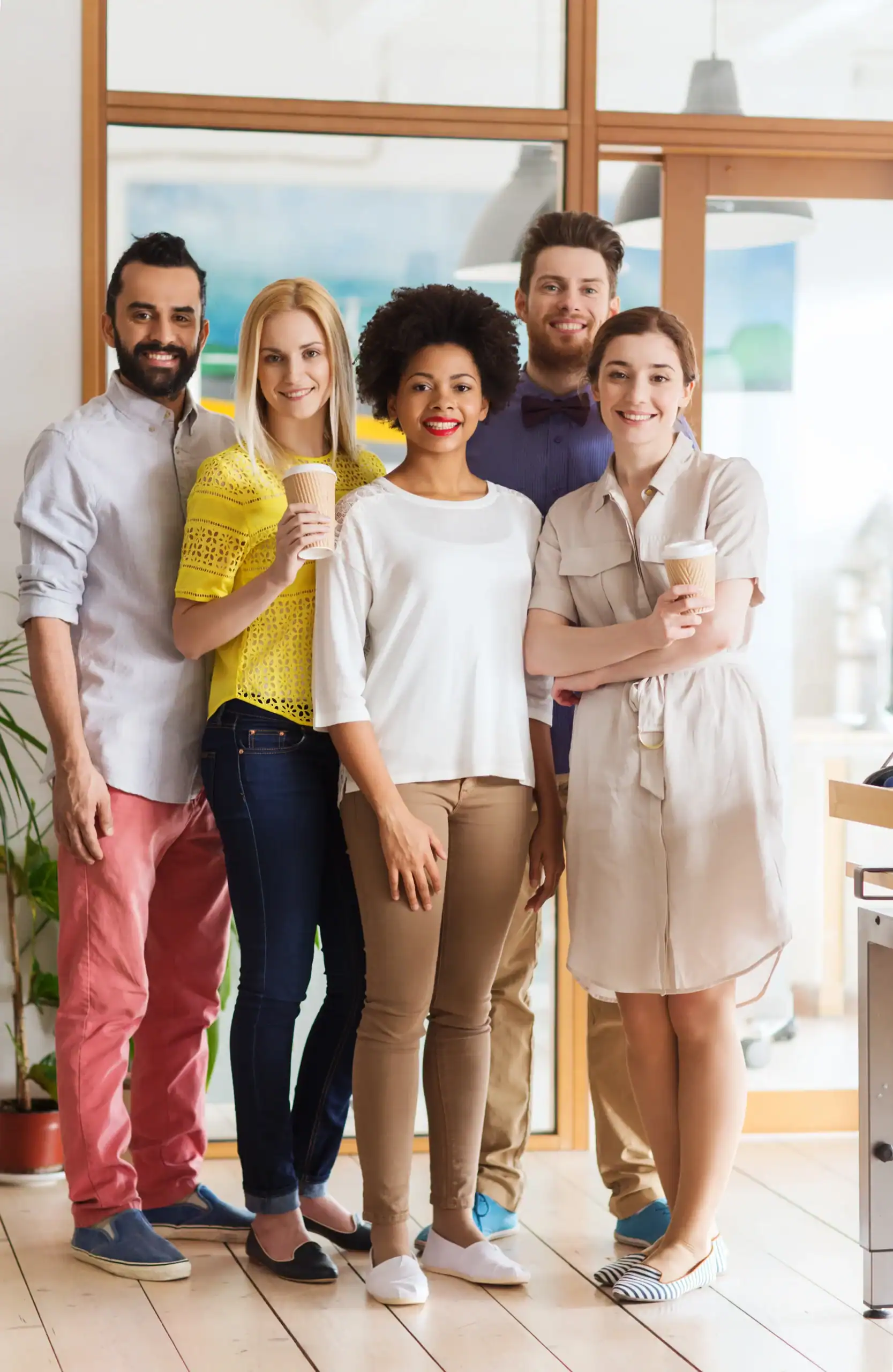 Team members posing together at work in a bright office