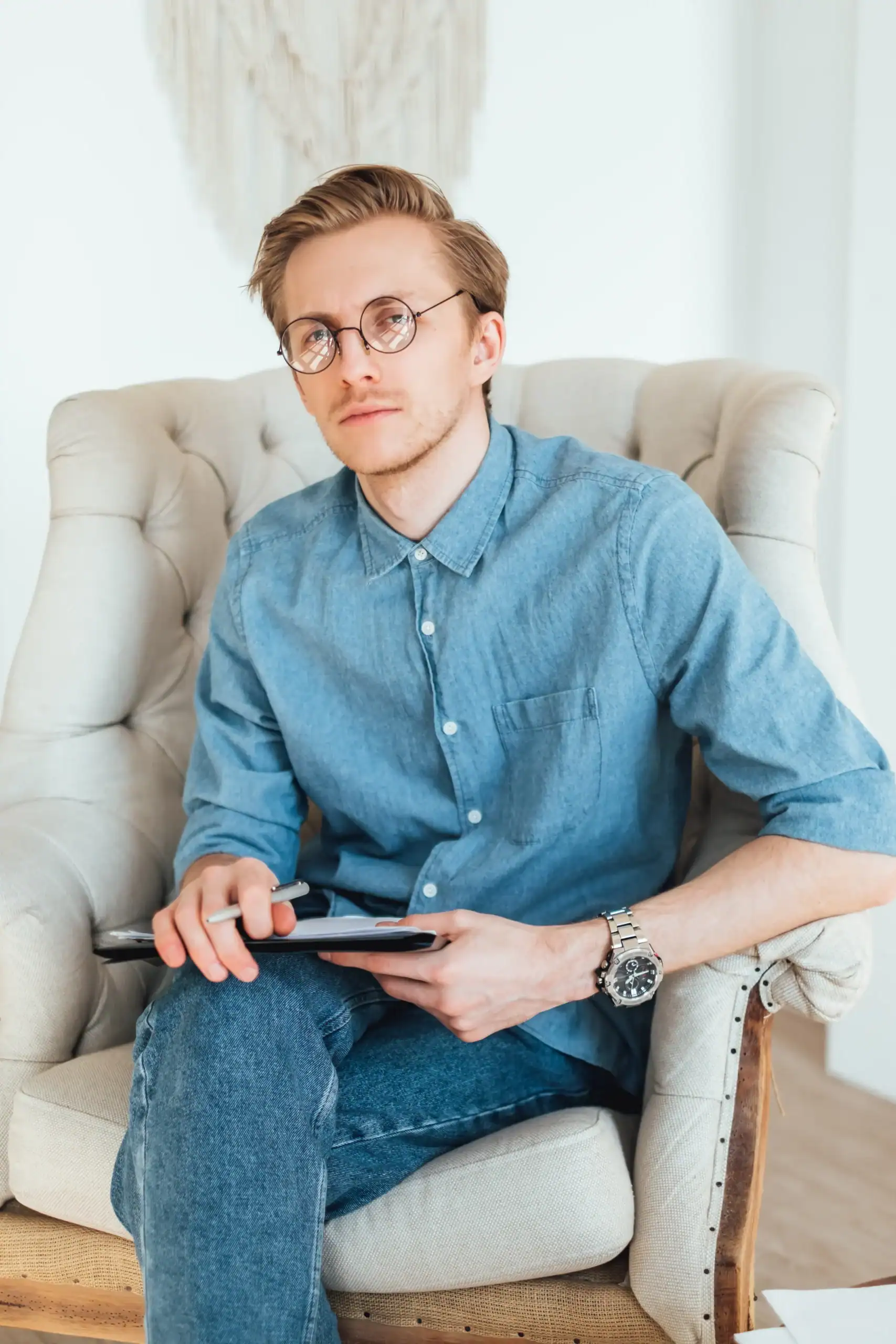 Mental health provider listening and writing on a notepad
