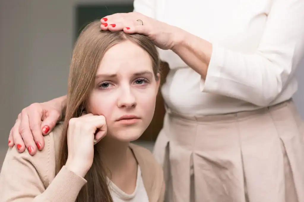 Young mother showing signs of postpartum depression while receiving emotional support