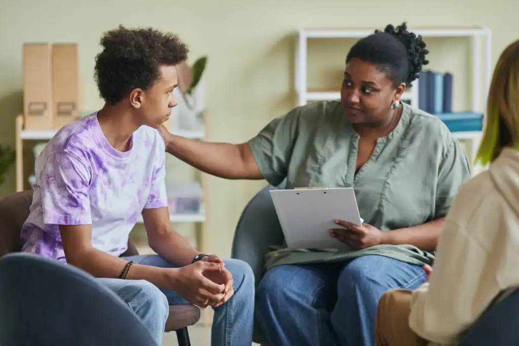 Group therapy participant receiving supportive contact from a therapist during a depression treatment session