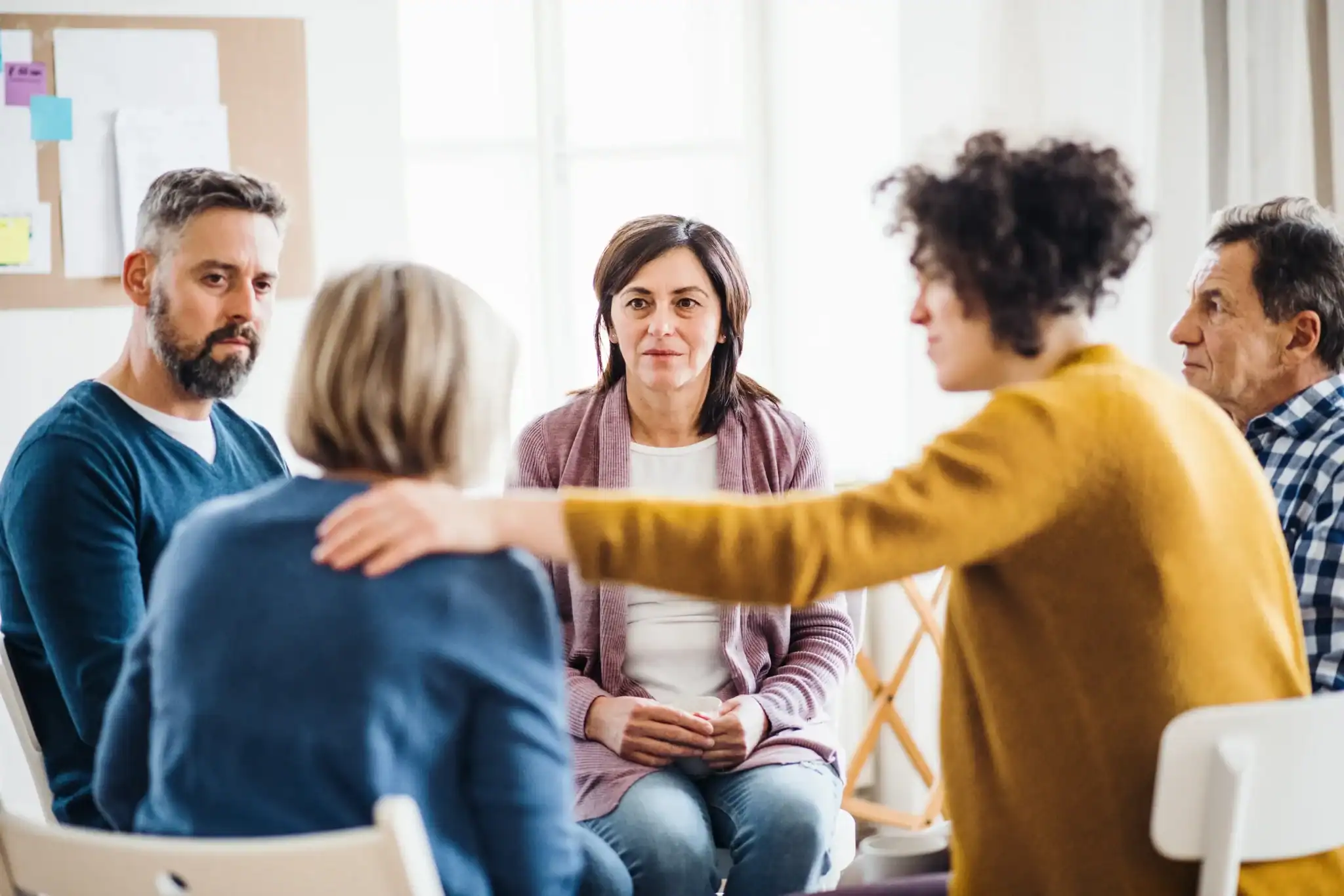 Adults in a group therapy session with supportive peer interaction, representing depression IOP treatment in New Jersey.