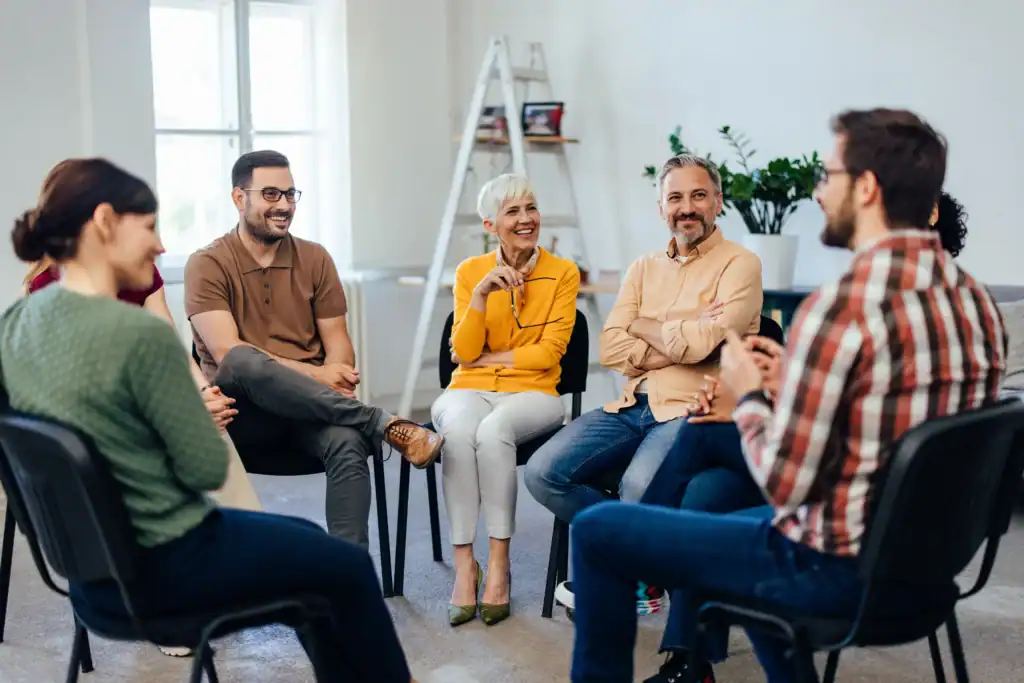 Small group of adults sitting in a circle during a structured group therapy session for depression
