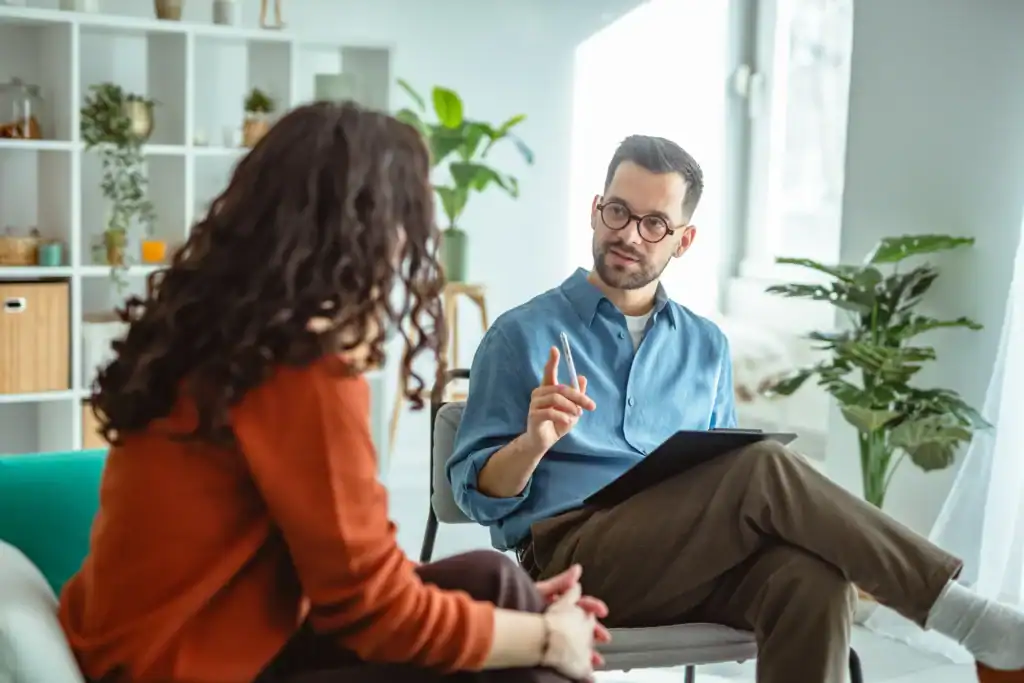 A licensed therapist conducting a structured depression treatment session with a patient