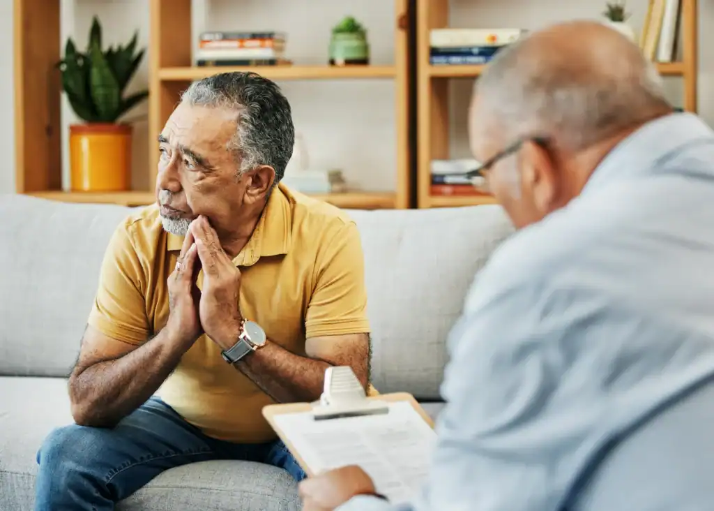 Older adult speaking with a therapist during a depression treatment session