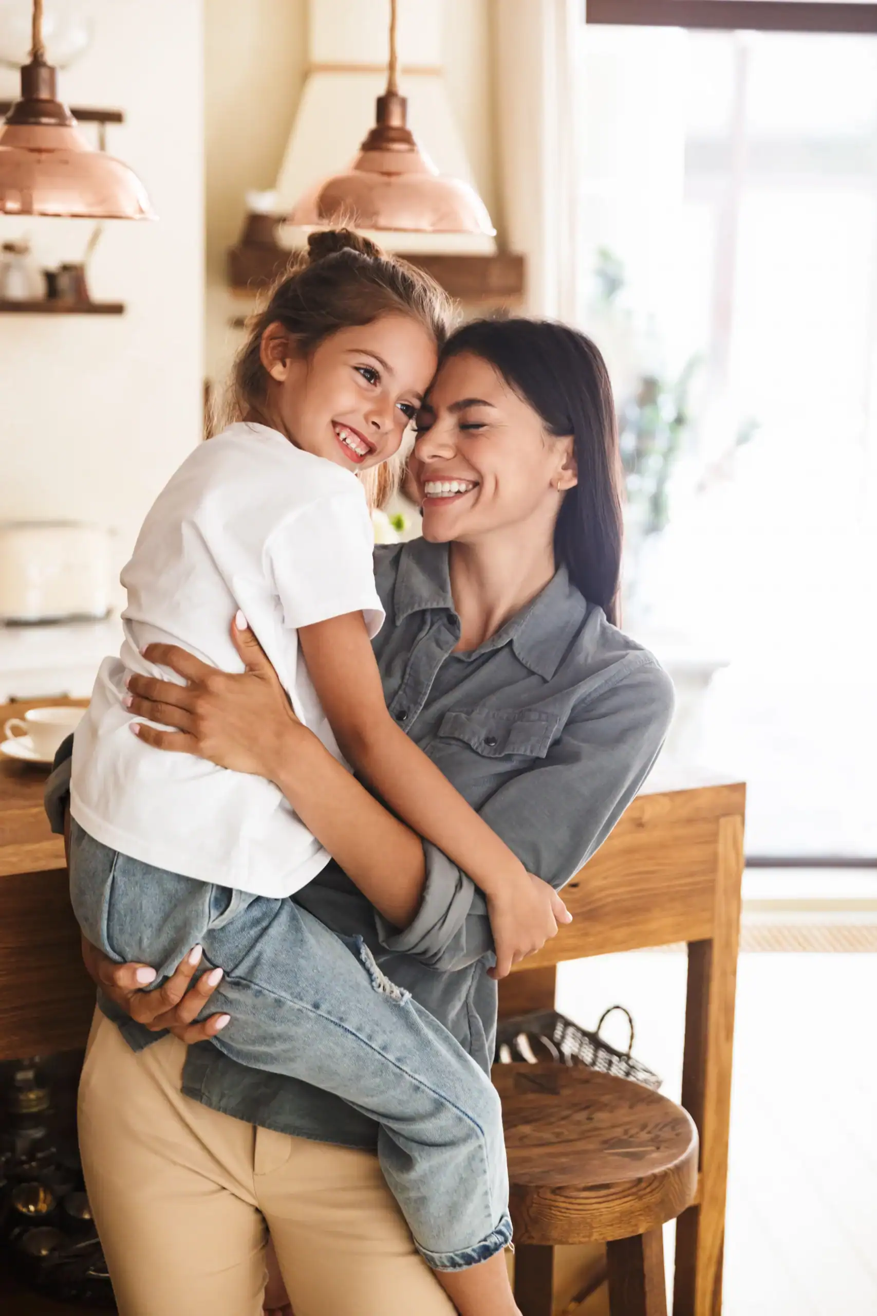 Woman embraces her child at home while reflecting on family support during mental health recovery.