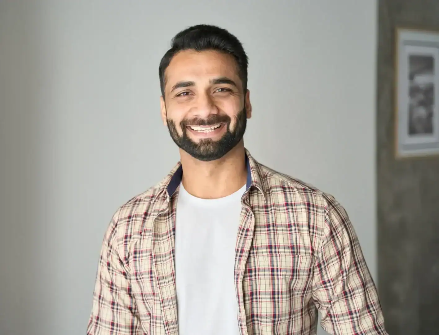 Man smiles in a calm office setting before starting mental health treatment.