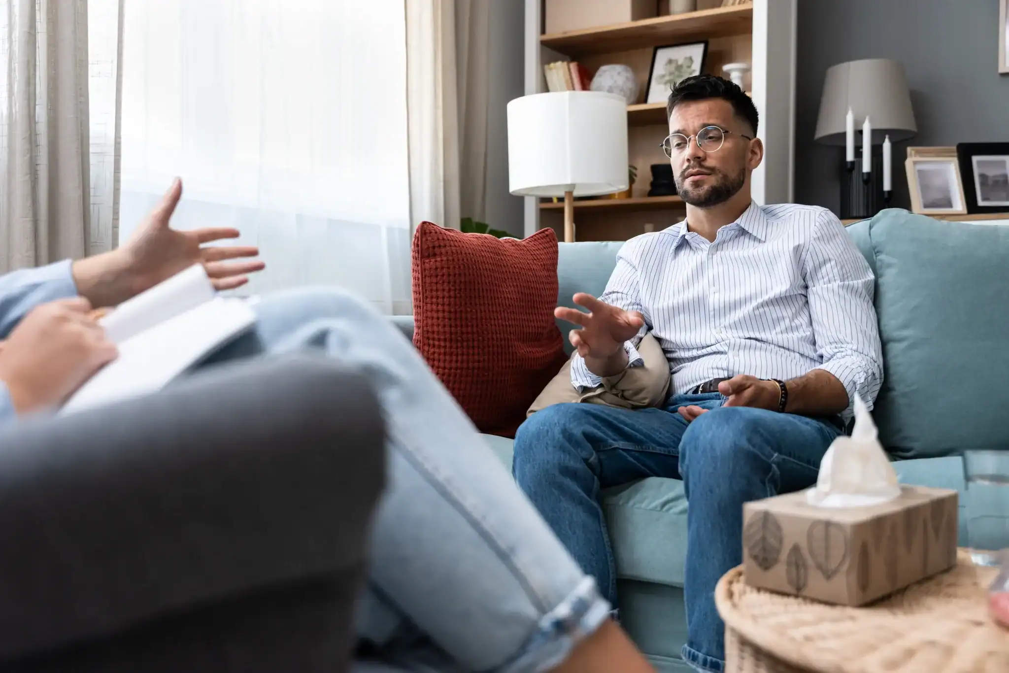 Man talking with a therapist during a counseling session for anxiety treatment.
