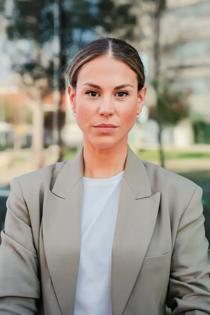 Professional in a beige blazer outdoors, representing mental health care for Mendham, NJ residents.