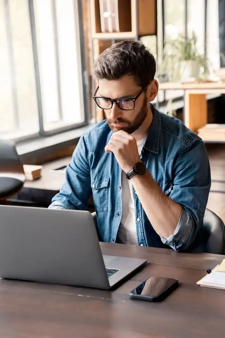 Man researching mental health and crisis resources on a laptop.